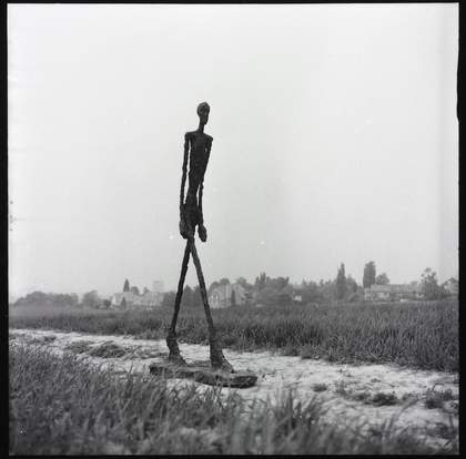Giacometti's Walking Man I, 1960 photographed by Ernst Scheidegger in the Swiss countryside, 1963