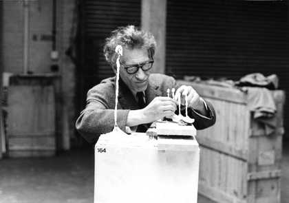 Giacometti working on Four Figurines on a Base, 1950-65 and Figurines of London II, 1965 in the basement of the Tate Gallery hours before the opening of his retrospective in 1965, photographed by Pierre Matisse