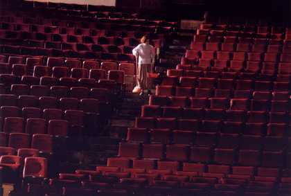 a man goes the stairs in a cinema