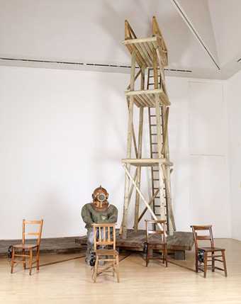 Goshka Macuga Objects in Relation 2007 a wooden diving stage with a deep sea diver sitting at the base