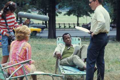 Still from a film with man lying on sun-lounger