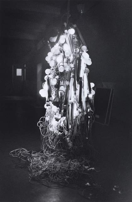 Otsuji Kiyoji’s photograph shows Tanaka Atsuko wearing her Electric Dress, made from electrical wires and painted neon light bulbs, at the 2nd Gutai Exhibition, Tokyo, 1956