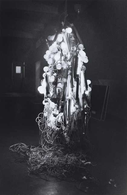 Otsuji Kiyoji’s photograph shows Tanaka Atsuko wearing her Electric Dress, made from electrical wires and painted neon light bulbs, at the 2nd Gutai Exhibition, Tokyo, 1956