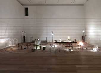 An arrangement of kitchen utensils, furniture, electric wire, light bulbs, computerised dimmer unit, amplifier, and speakers.