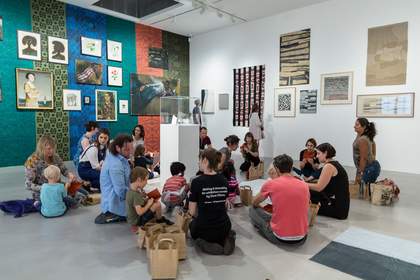 Photograph of two people viewing a painting