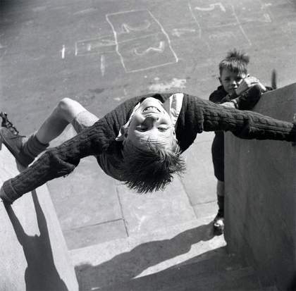 photograph of two boys in a playground, from about 1953