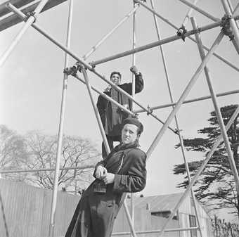 Photograph of Eduardo Paolozzi and unidentified man on scaffolding by Nigel henderson