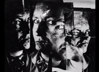 Film still from Nigel Henderson film showing a stressed black and white photograph