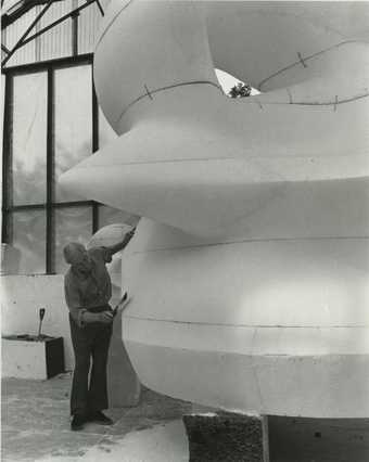 Henry Moore working on the polystyrene enlargement for Large Square Form with Cut 1969–71 at Perry Green