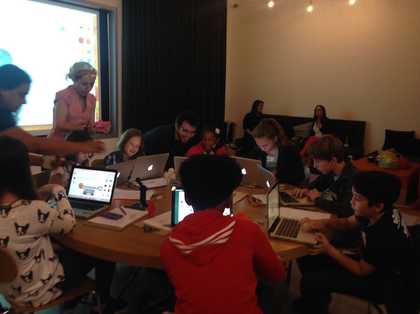 Kids working on their 3D designs at computers