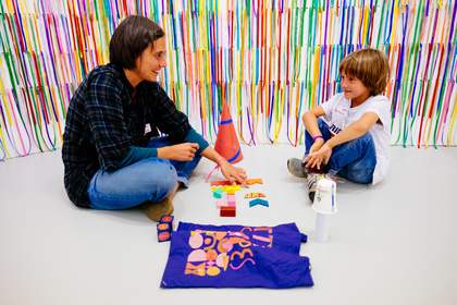 Adult and child play with colourful shapes and textures