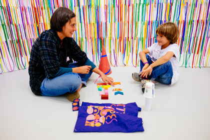 Adult and child play with colourful shapes and textures