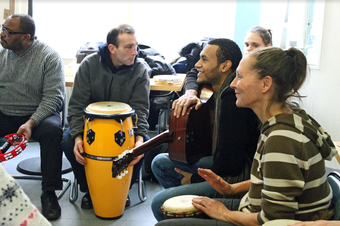 a group of people playing music and talking