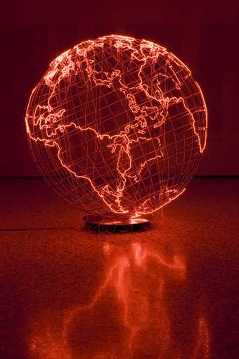 Wire globe with areas of land marked out by thin, red, neon tubes.