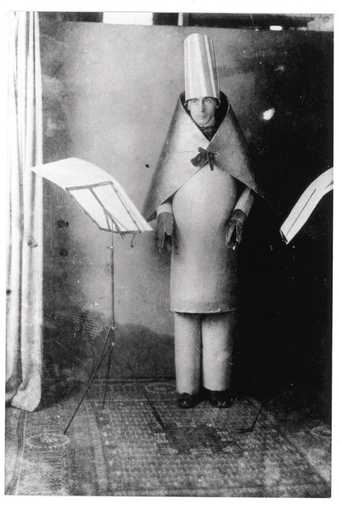 Hugo Ball reciting Karawane in a cubist costume at the Cabaret Voltaire, Zürich 1916