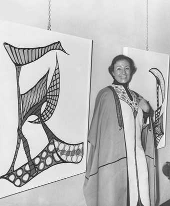Huguette Caland wearing one of her signature kaftans in her first solo exhibition at Dar El Fan, Beirut, 1970