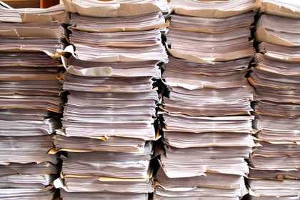 Stacks of newspapers produced by Art in Liverpool