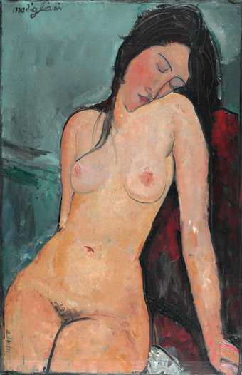 a woman sits on a chair nude