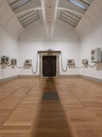 photo of a gallery room with air conditioning units arranged along the walls