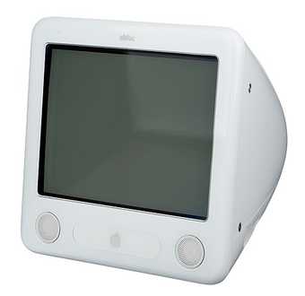 A white desktop computer with a square grey screen, tapering towards the back