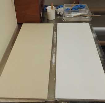 Two stretched cotton canvases – one unprimed (left) and the other primed with white alkyd paint (right) – being used as mock-ups for cleaning tests.