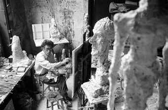 Giacometti in his studio painting