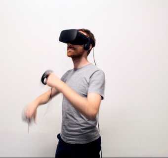 Photograph of a man wearing a virtual reality headset