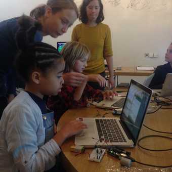 Photograph of kids at a computer