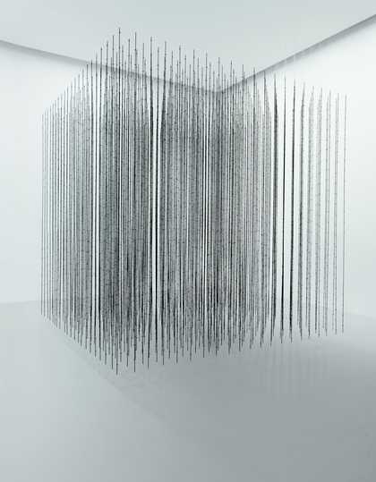 A white room with a floating cube in the centre made up of black wire pieces