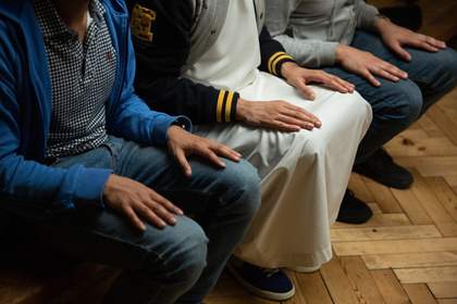 hands resting on knees
