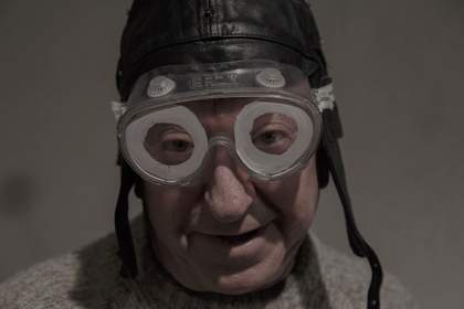 close up of a man wearing googles and a swimming hat