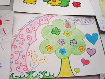 Kids drawing of a tree with flowers and love hearts around it