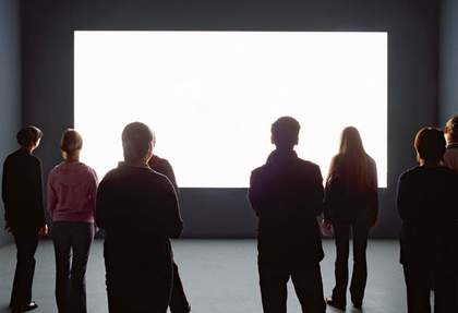 Installation view of Alredo Jaars Lament of the Images 2002 at the Louisiana Museum of Modern Art visitors watching a projection of a white rectangle in a gallery
