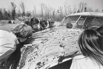 Sol Goldberg photograph of participants in Allan Kaprow Women licking jam off a car