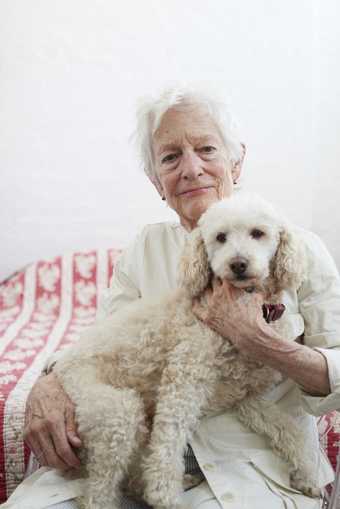 Photograph of artist Joan Jonas with a dog