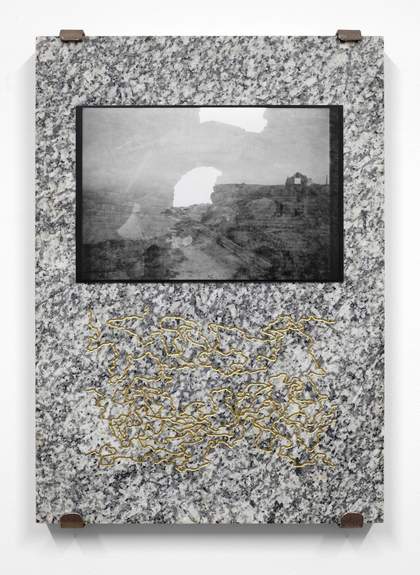 Black and white tv monitor set in a granite slab of stone