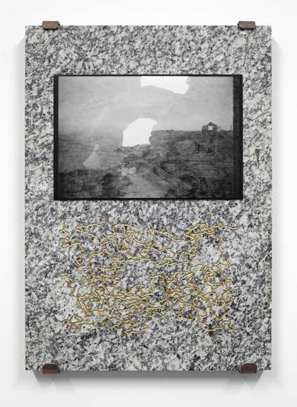Black and white tv monitor set in a granite slab of stone