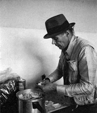 Joseph Beuys cooking stew in his Dusseldorf studio 1984