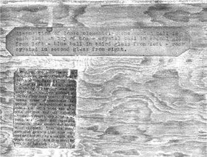 Joseph Cornell Close-up of label at top left giving detailed directions about the placement of the elements of Planet Set, typed presumably by Cornell. Underneath it is the press cutting cited at the