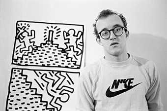 Keith Haring stood in front of a drawing
