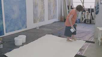 Judy Watson painting in her studio