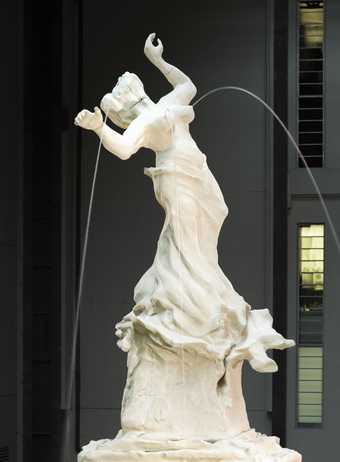 Photograph of a fountain made from a sculpture of a female figure