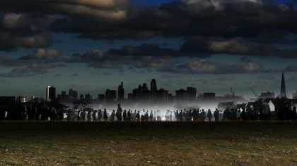 Dusk photograph of a skyline showing a series of illustrated figures in the background