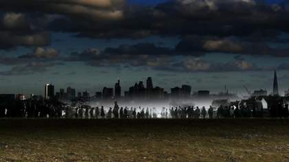 Dusk photograph of a skyline showing a series of illustrated figures in the background