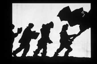 silhouettes of figures holding a flag