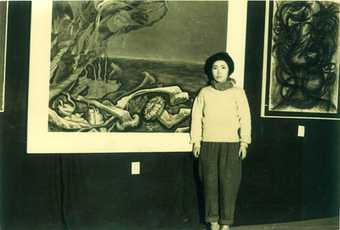 Kusama standing in front of 'Lingering Dream', selected for the Second Creative Arts Exhibition in Nagano, 1951.