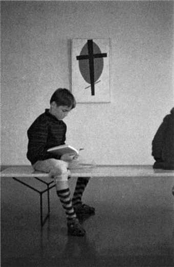 Wolfgang Laib, aged eight, at Ulm Museum sitting in front of Malevich’s Mystic Suprematism (black cross on red oval) 1920-2