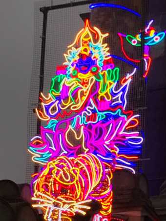 Goddess Lakshmi sitting on a lotus flower, made out of neon