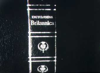 A black and white photocopy of the spine of a book.