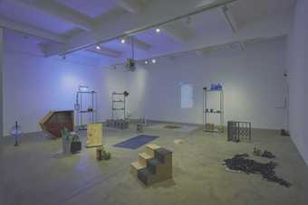 Photograph of the installation 'earwitness inventory' showing a series of found objects arranged within a large room
